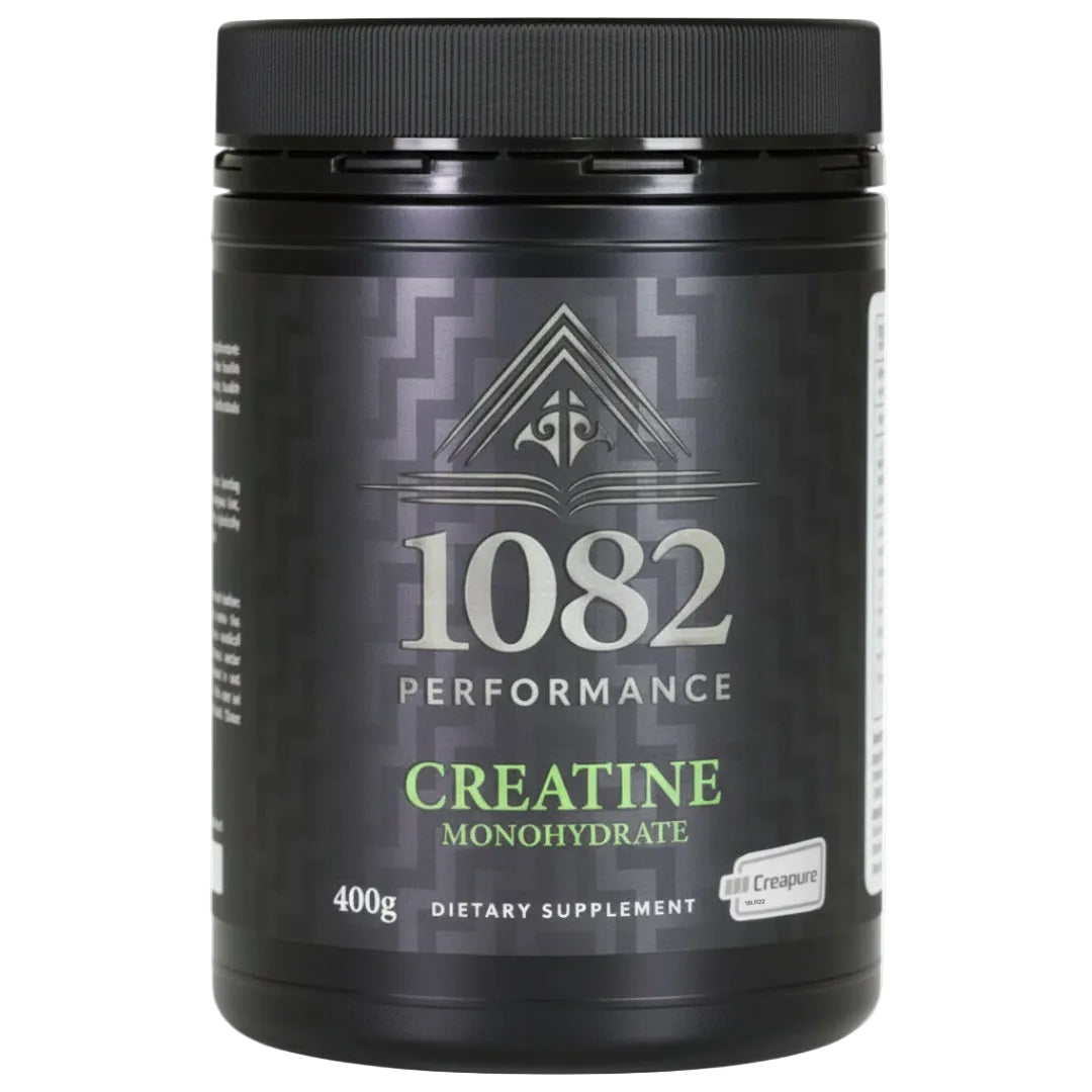 Black supplement container labeled '1082 Performance Creatine Monohydrate' on a white background