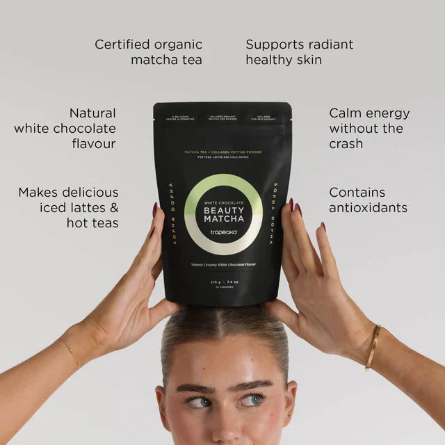 Person holding a bag of Beauty Matcha tea with text highlighting its benefits on a white background