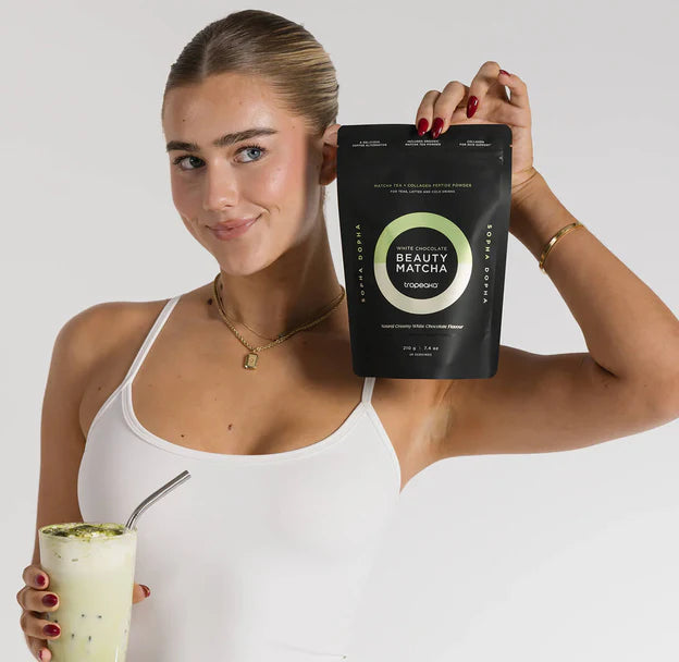Woman holding a package of Beauty Matcha and a matcha drink.