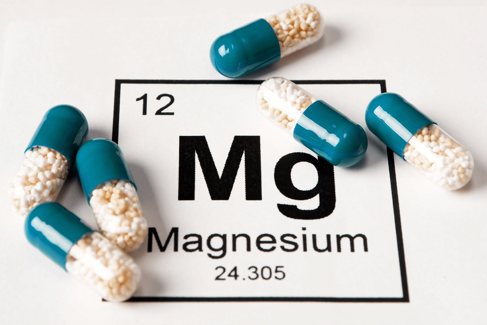 Pills on the period table sections of Magnesium