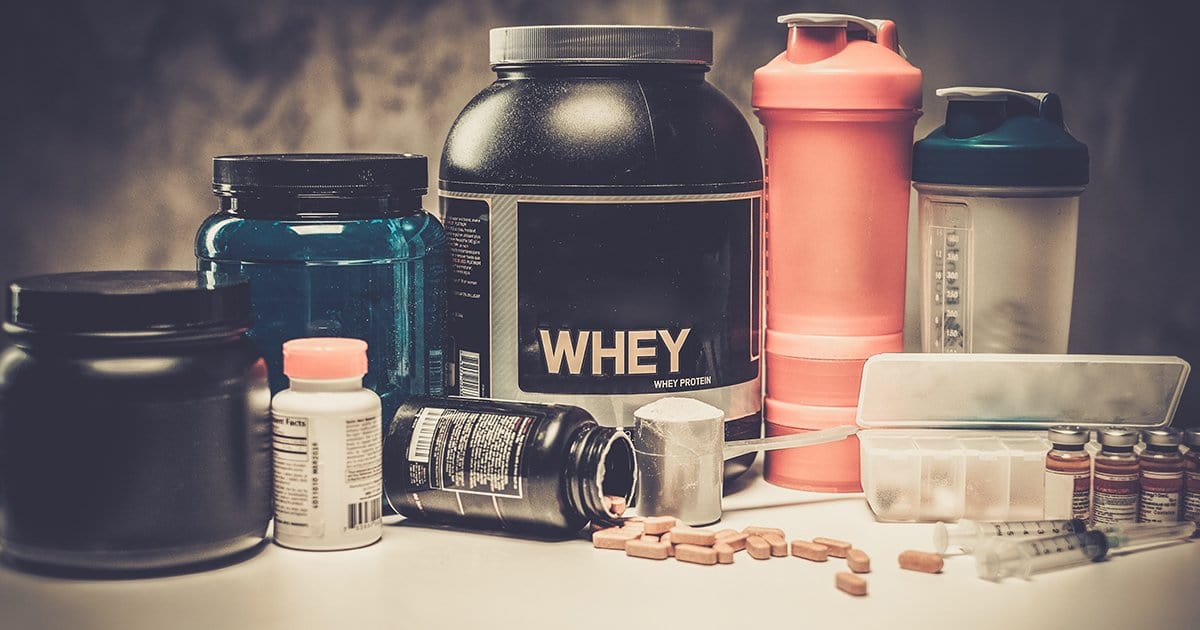 Different kind of containers, tubes and shakers filled with sport supplements