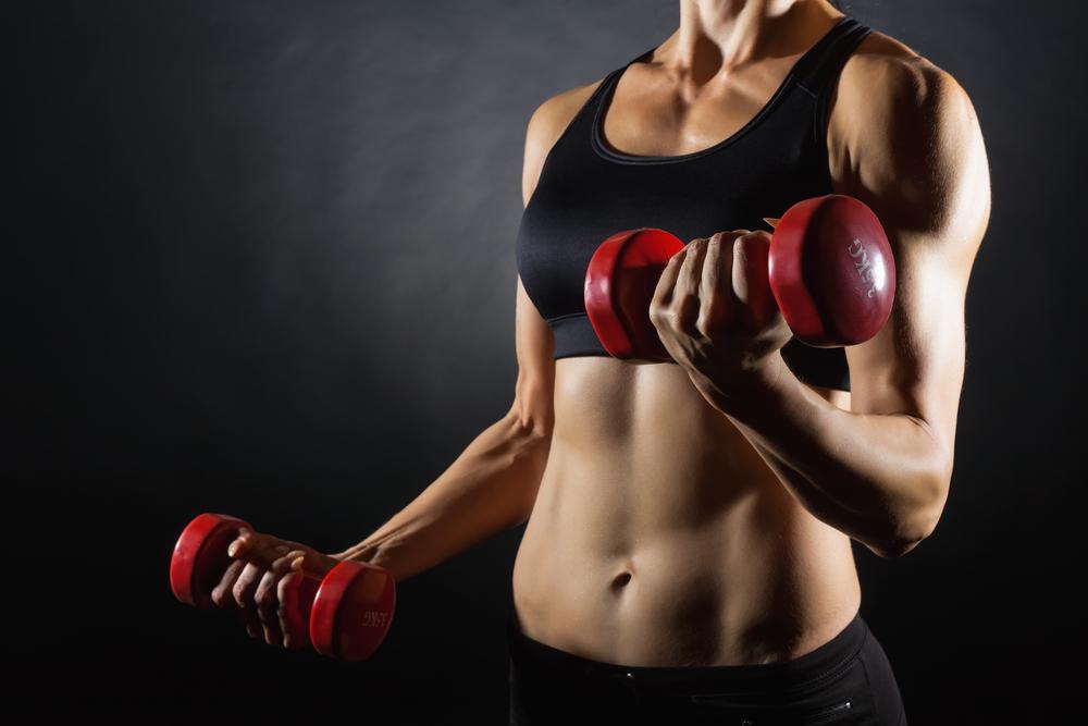 Upper woman's body holding dumbbells