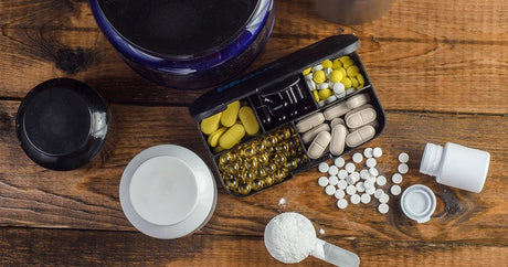 Different coloured pills and powders on a table