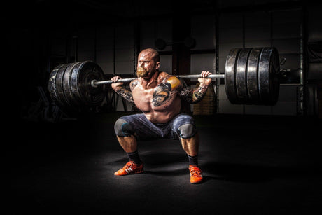 Strong & toned man at the bottom of a heavy back-squat.