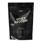 Black packaging of clean nutrition whey protein with 'cookies & cream' flavor on a white background