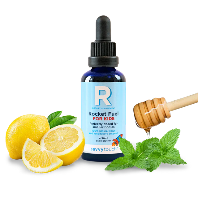 Bottle of 'Rocket Fuel for Kids' with lemons, honey, and mint leaves on a white background