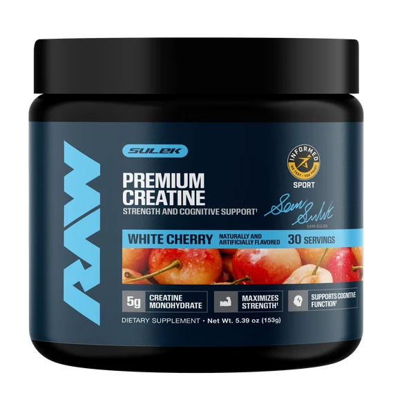 A black plastic tub of Sulek RAW Premium Creatine in White Cherry flavor, featuring a dark blue label with light blue branding and a graphic of red cherries.