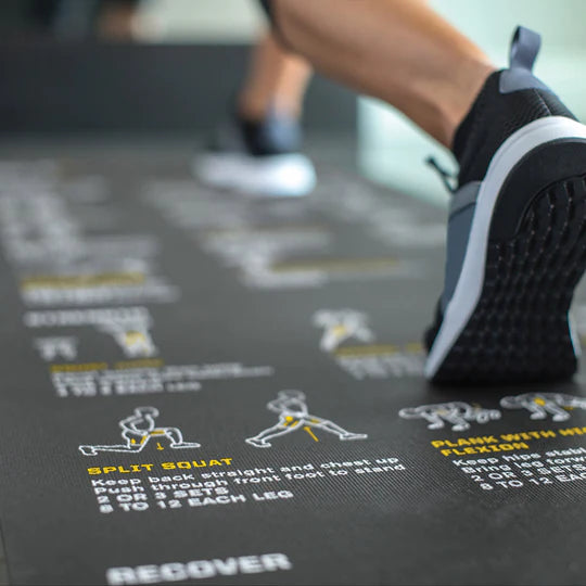 Person exercising on a fitness mat with exercise instructions.