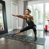 Woman practicing yoga on a mat in a home setting
