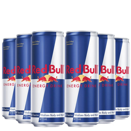 Multiple cans of Red Bull energy drink arranged in a row on a white background